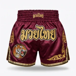 Custom Muay Thai Shorts – Burgundy with Tiger Patch Burgundy Muay Thai shorts with gold Thai script and tiger patch
