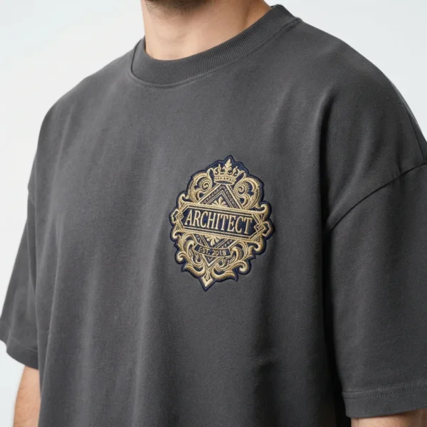 Custom Streetwear T-Shirt – Charcoal Embroidered Badge Charcoal t-shirt with embroidered badge on model