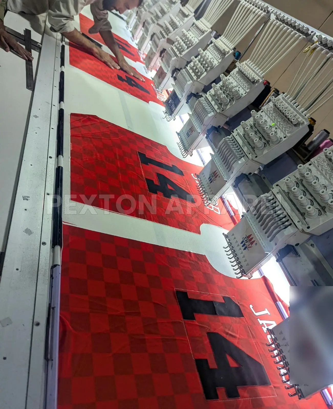 Embroidering numbers on sublimated jerseys at Pexton Apparel