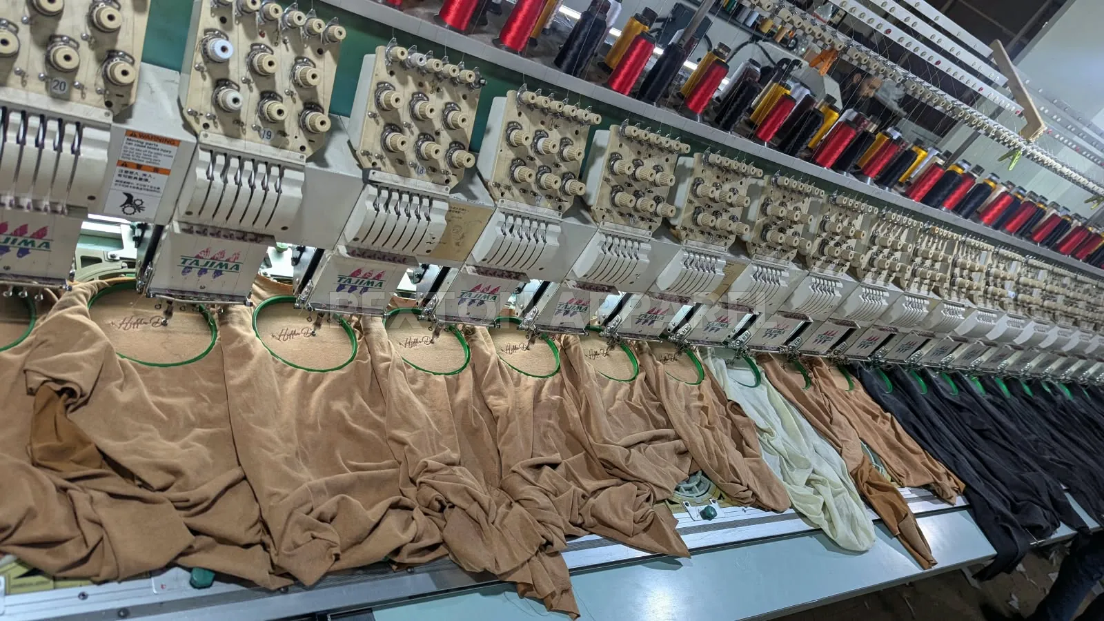 Multi-head embroidery machine working on garments at Pexton Apparel